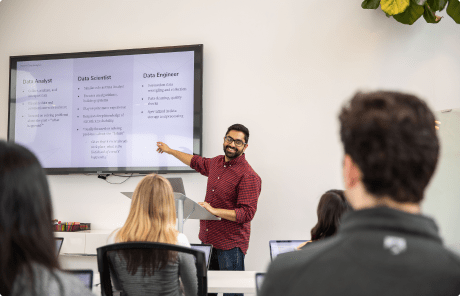 Coding bootcamps NYC students in a classroom attending a data science lecture.