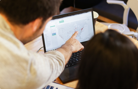 Students gathered around a computer analyzing data at BrainStation Toronto.