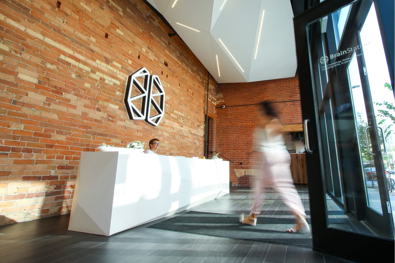 guy sitting at the reception of BrainStation